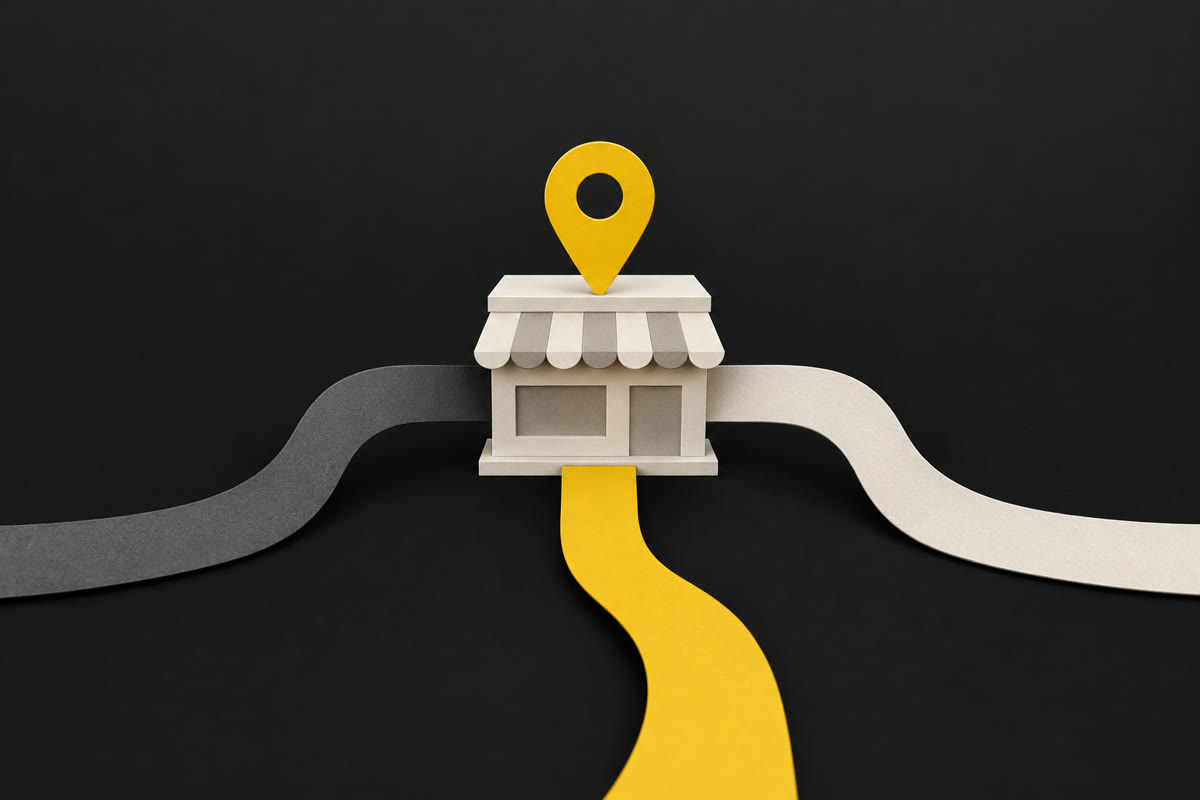 Illustration of a paper shopfront on charcoal with three paper strands feeding into it and a yellow map pin on top.